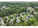 Aerial view of neighborhood with mature trees, some homes featuring in-ground pools, and nearby lake at 3011 Stillwater Dr, Villa Rica, GA 30180