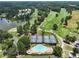 Aerial view of the golf course, lake, tennis courts, and swimming pool at 3011 Stillwater Dr, Villa Rica, GA 30180