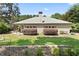 Beautiful view of home exterior from backyard with manicured lawn, mature trees, and lush landscaping at 3011 Stillwater Dr, Villa Rica, GA 30180
