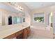 Bright bathroom featuring a large mirror, tub and shower at 3011 Stillwater Dr, Villa Rica, GA 30180