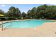 Community pool with lounge chairs and umbrellas, perfect for relaxing and enjoying the outdoors at 3011 Stillwater Dr, Villa Rica, GA 30180