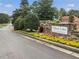 Community entrance with the Mirror Lake sign surrounded by colorful flowers, trees, and manicured landscaping at 3011 Stillwater Dr, Villa Rica, GA 30180