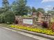 Stone sign for Mirror Lake, a lake and golf community, surrounded by colorful flowers and lush landscaping at 3011 Stillwater Dr, Villa Rica, GA 30180