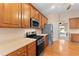 Kitchen features stainless appliances, oak cabinets and hardwood floors at 3011 Stillwater Dr, Villa Rica, GA 30180