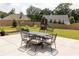 Backyard patio with outdoor dining set and a play set, all set in a fenced in yard, perfect for entertaining at 5985 Hidden Ridge Ct, Cumming, GA 30028