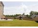 Large backyard showcasing a concrete patio, play set and a sprawling lawn at 5985 Hidden Ridge Ct, Cumming, GA 30028