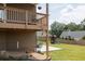 Exterior shot from under the deck showing the patio, play set, and backyard at 5985 Hidden Ridge Ct, Cumming, GA 30028