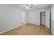 Bright bedroom featuring wood-look floors, ceiling fan, closet, and neutral paint at 1260 White Oak Se St, Conyers, GA 30013