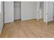 Bright bedroom featuring wood-look floors, neutral paint, and closet at 1260 White Oak Se St, Conyers, GA 30013