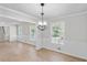 Open dining room with light fixture, wood flooring, and classic white wainscoting for elegant meals at 1260 White Oak Se St, Conyers, GA 30013