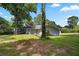 Exterior view showcasing the house, grassy lawn, and surrounding trees at 1260 White Oak Se St, Conyers, GA 30013