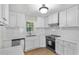 Modern kitchen boasts new stainless appliances, bright white cabinetry, and sleek, clean countertops at 1260 White Oak Se St, Conyers, GA 30013