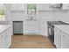 Bright kitchen features modern stainless steel appliances, sleek countertops, and ample white cabinets at 1260 White Oak Se St, Conyers, GA 30013