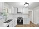 Modern kitchen features stainless appliances, bright white cabinetry, and sleek, clean countertops at 1260 White Oak Se St, Conyers, GA 30013
