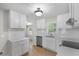 Modern kitchen features stainless appliances, bright white cabinetry, and sleek, clean countertops at 1260 White Oak Se St, Conyers, GA 30013