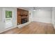 Bright living room featuring a brick fireplace, wood floors, and paneled walls at 1260 White Oak Se St, Conyers, GA 30013