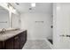 Bathroom with marble floors, double sinks, a walk-in shower, and elegant lighting at 356 Lake Dr, Atlanta, GA 30354