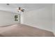 Spacious bedroom featuring a ceiling fan, natural light, and neutral colored carpet at 356 Lake Dr, Atlanta, GA 30354