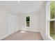 Bright bedroom featuring neutral carpet, natural light from two windows, and a large closet at 356 Lake Dr, Atlanta, GA 30354