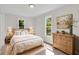 Light-filled bedroom featuring neutral colors, wood accents, and two windows at 356 Lake Dr, Atlanta, GA 30354