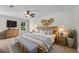 Spacious main bedroom featuring a ceiling fan, two large windows, and a neutral colored carpet at 356 Lake Dr, Atlanta, GA 30354