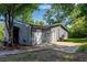 Rear exterior view of the home with a white door, windows, and landscaped yard at 356 Lake Dr, Atlanta, GA 30354