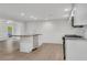 Bright kitchen with white cabinets, granite counters, stainless appliances, and an island overlooking the living space at 356 Lake Dr, Atlanta, GA 30354