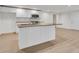 Bright kitchen features white cabinets, granite counters, stainless appliances and an island at 356 Lake Dr, Atlanta, GA 30354