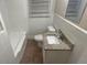 Bathroom featuring a granite-topped vanity and tiled tub surround at 2083 Meador Se Ave, Atlanta, GA 30315