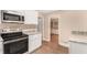 Modern kitchen boasts granite countertops, stainless steel appliances, and views into another room at 2083 Meador Se Ave, Atlanta, GA 30315