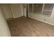 Living room with laminate wood flooring, white baseboards, and large bright windows at 2083 Meador Se Ave, Atlanta, GA 30315