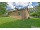 The backyard of this residence provides a lush lawn and charming landscape in a suburban setting at 219 1St St, Woodstock, GA 30188