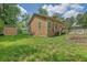 Backyard with a storage shed features a well-maintained lawn and partial fencing for outdoor enjoyment at 219 1St St, Woodstock, GA 30188