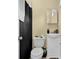 Compact bathroom featuring a toilet, vanity, and shower with a black shower curtain at 219 1St St, Woodstock, GA 30188