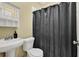 Clean bathroom featuring a sink, toilet, and shower with modern fixtures and practical design at 219 1St St, Woodstock, GA 30188