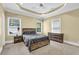 Comfortable bedroom features a ceiling fan, neutral walls, and ample natural light from multiple windows at 219 1St St, Woodstock, GA 30188