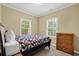 Inviting bedroom showcasing natural light, a comfortable bed, and classic wooden furnishings for a serene retreat at 219 1St St, Woodstock, GA 30188