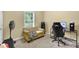 Comfortable bedroom featuring a cozy sofa, desk setup, and ample natural light for a relaxing ambiance at 219 1St St, Woodstock, GA 30188