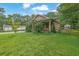 A beautiful house sits on a lush green lawn with mature trees at 219 1St St, Woodstock, GA 30188