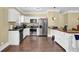 Well-lit kitchen featuring stainless steel appliances, white cabinets, and a convenient breakfast bar at 219 1St St, Woodstock, GA 30188