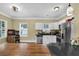 Open kitchen showcasing ample natural light, white cabinetry, granite countertops, and stainless steel appliances at 219 1St St, Woodstock, GA 30188