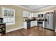 Functional kitchen design with stainless steel appliances, white cabinetry, and efficient layout for meal preparation at 219 1St St, Woodstock, GA 30188