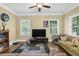 Comfortable living room with large windows, hardwood floors, and stylish decor at 219 1St St, Woodstock, GA 30188