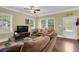 Bright living room featuring hardwood floors, comfortable seating, and lots of windows at 219 1St St, Woodstock, GA 30188