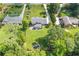 Property's backyard featuring a pond and mature trees, complementing the classic architecture of the two-story residence at 425 Houze Way, Roswell, GA 30076