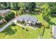 Aerial shot of a well-maintained property featuring a spacious backyard, mature trees, and a classic two-story house at 425 Houze Way, Roswell, GA 30076
