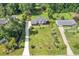 Aerial view of a traditional two-story home with a large front yard, mature landscaping, and a long driveway at 425 Houze Way, Roswell, GA 30076