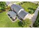 A classic residence showcases a well-maintained roof and inviting covered deck, surrounded by lush landscaping at 425 Houze Way, Roswell, GA 30076