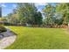 Large, level backyard with a wooden fence, providing privacy and space for outdoor activities and a storage shed at 425 Houze Way, Roswell, GA 30076