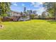 Spacious backyard with lush green grass and mature trees, offering plenty of room for recreation and relaxation at 425 Houze Way, Roswell, GA 30076